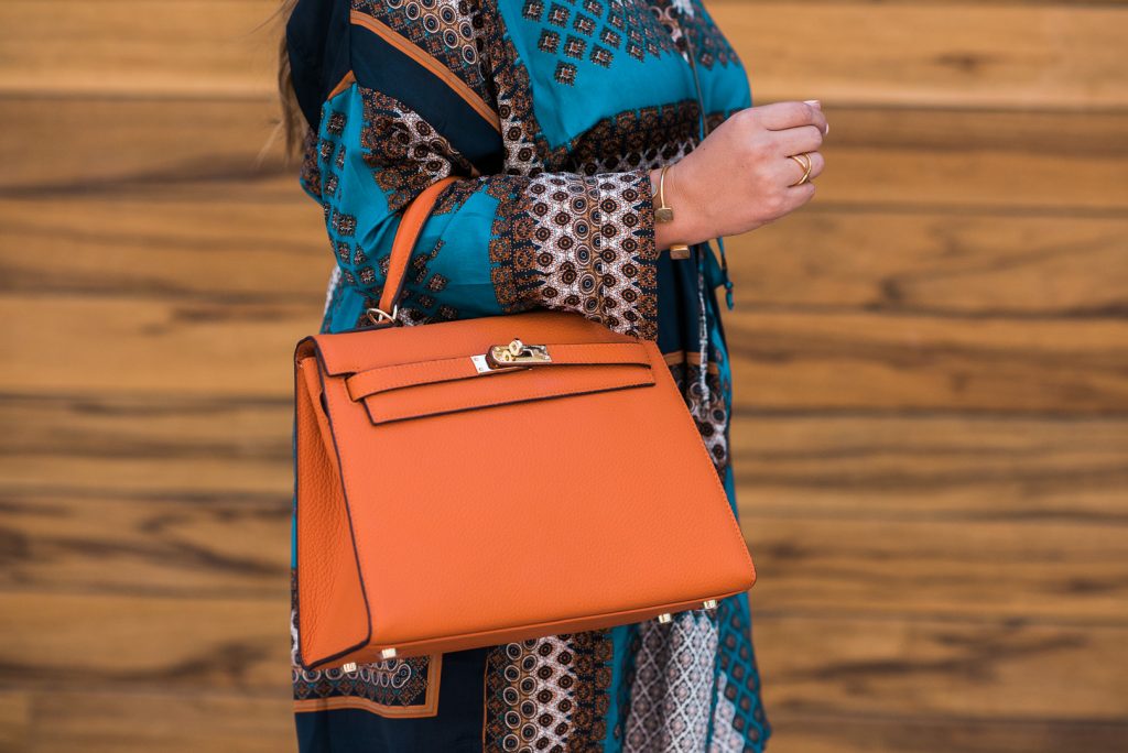 Ashley Zeal of Two Peas in a Prada Printed Shirtdress, orange purse