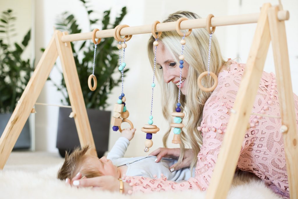 Emily Farren Wieczorek of Two Peas in a Prada plays with her infant son under a BoandRoo natural wooden baby gym and talks about the best new baby products of 2017.
