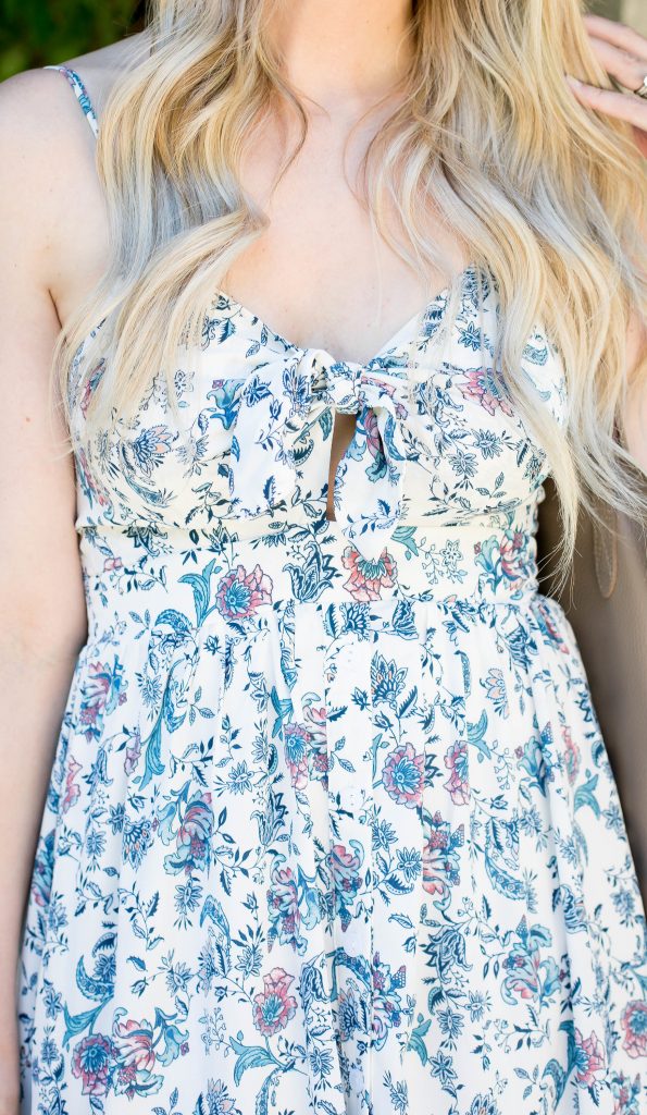 Emily Farren Wieczorek of Two Peas in a Prada wears a floral midi dress from Nordstrom for summer. 
