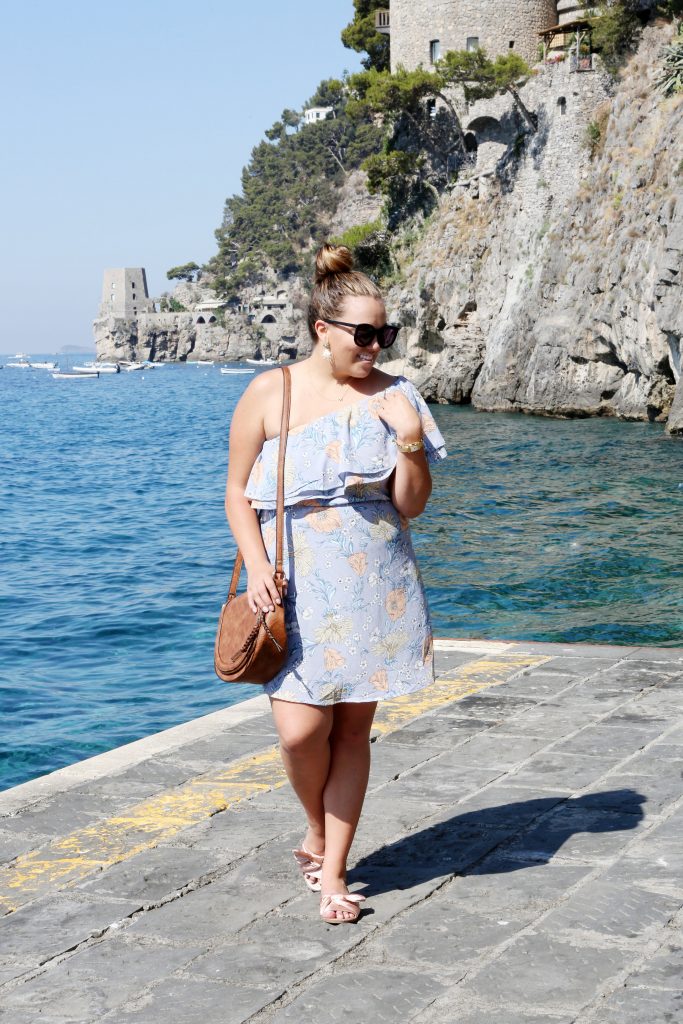 Ashley from Two Peas in a Prada wears a ruffle dress that is currently on sale for less than $30 making it 40% off! This is the perfect summer dress. 