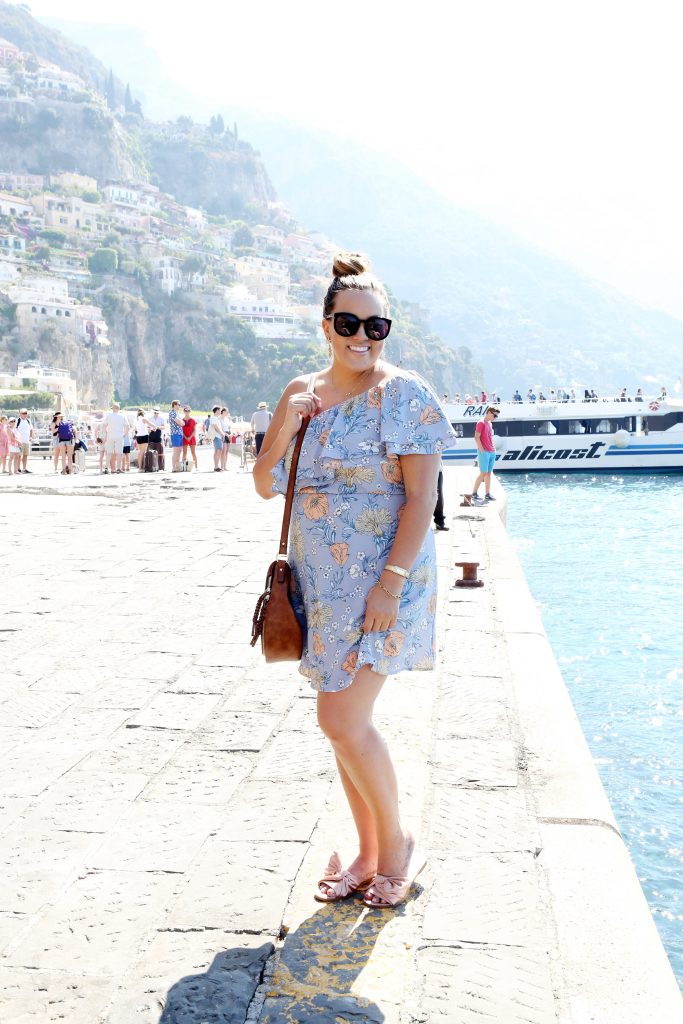 Ashley from Two Peas in a Prada wears a ruffle dress that is currently on sale for less than $30 making it 40% off! This is the perfect summer dress. 