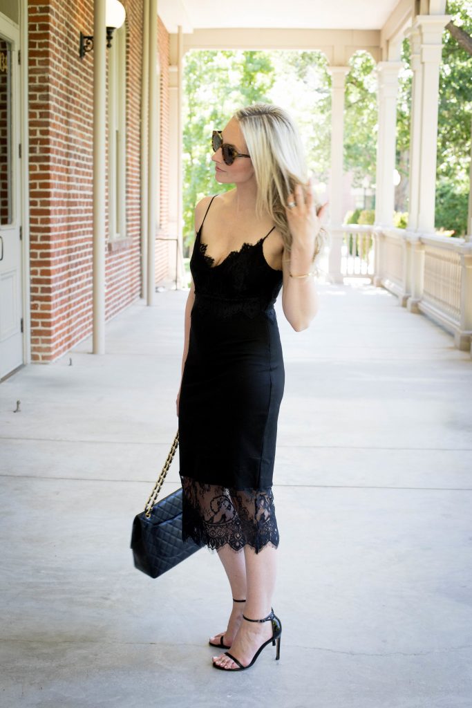 Emily Farren Wieczorek of Two Peas in a Prada wears a black, lace slip dress for date night with Karen Walker sunglasses, stuart weitzman nudist pumps and a Chanel purse. 