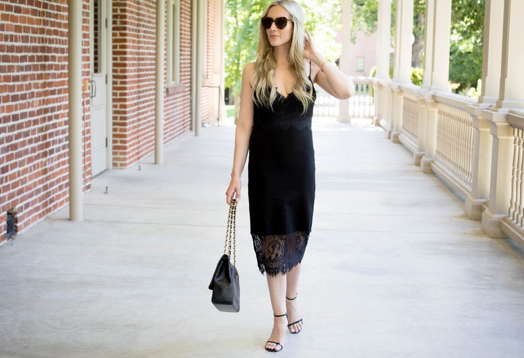 Emily Farren Wieczorek of Two Peas in a Prada wears a black, lace slip dress for date night with Karen Walker sunglasses, stuart weitzman nudist pumps and a Chanel purse. 
