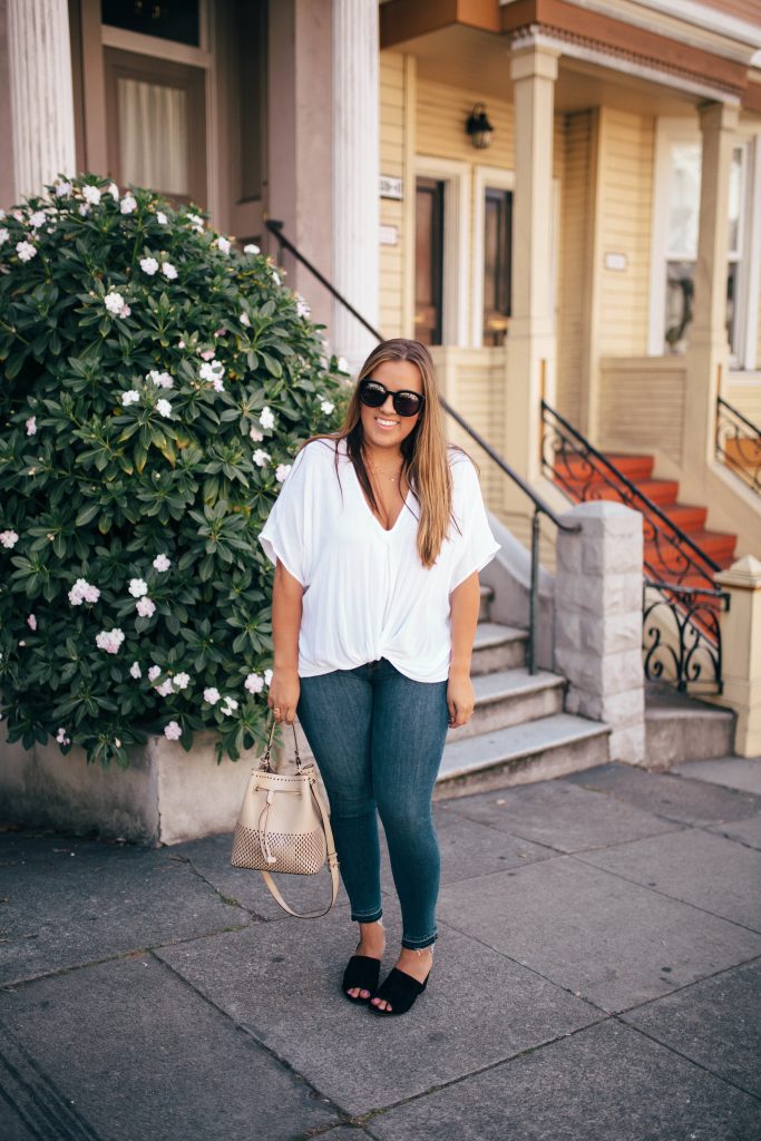 Ashley Zeal from Two Peas in a Prada wears an upgraded white tee, Good American Jeans and a Furla bucket bag in San Francisco. 