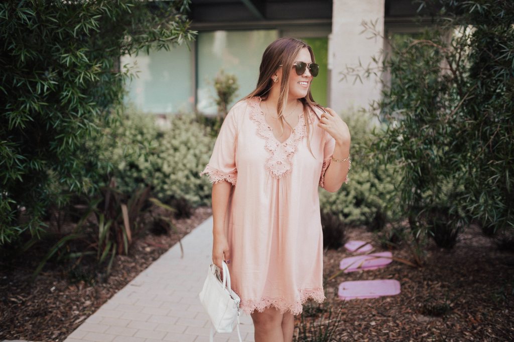 Ashley Zeal from Two Peas in a Prada shares a long sleeved pink dress with lace detail for under $50 and many similar items. 
