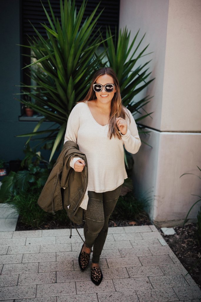 Ashley Zeal from Two Peas in a Prada shares "The Outfit I Can't Stop Wearing." Featuring moto leggings, leather slides and a long sleeved thermal. 