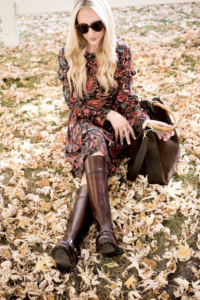 Emily Farren Wieczorek of Two Peas in a Prada wears a floral dress and knee high riding boots by Two24 by Ariat from Zappos.