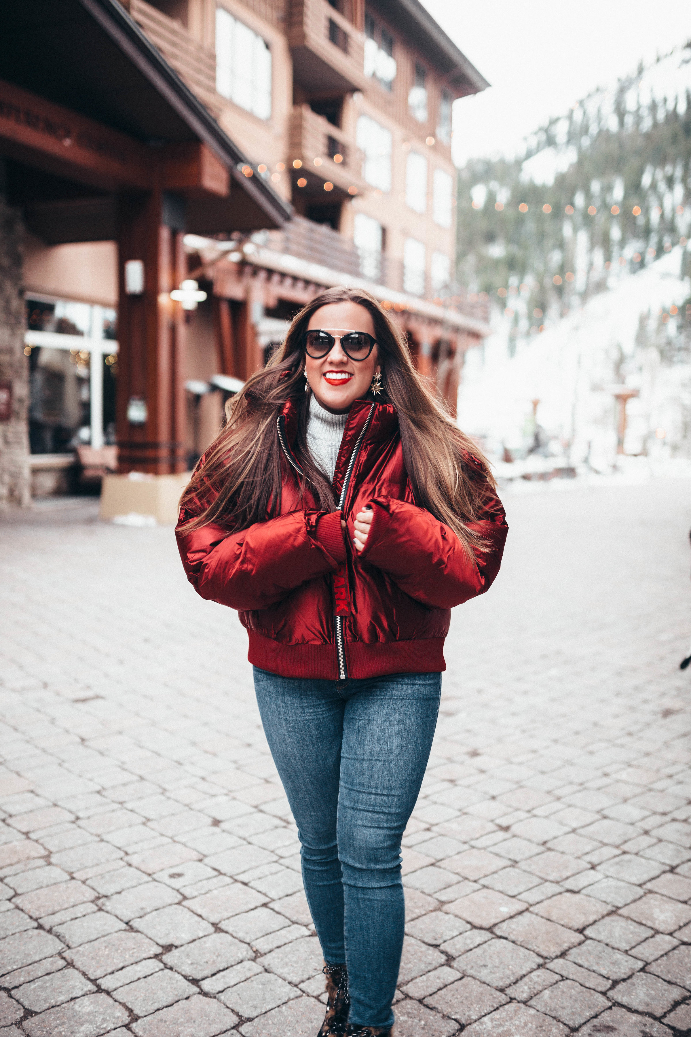 Ashley Zeal from Two Peas in a Prada shares a life and health update. She is wearing an Ivy Park Puffer jacket, Good American Jeans and Sam Edelman boots. 