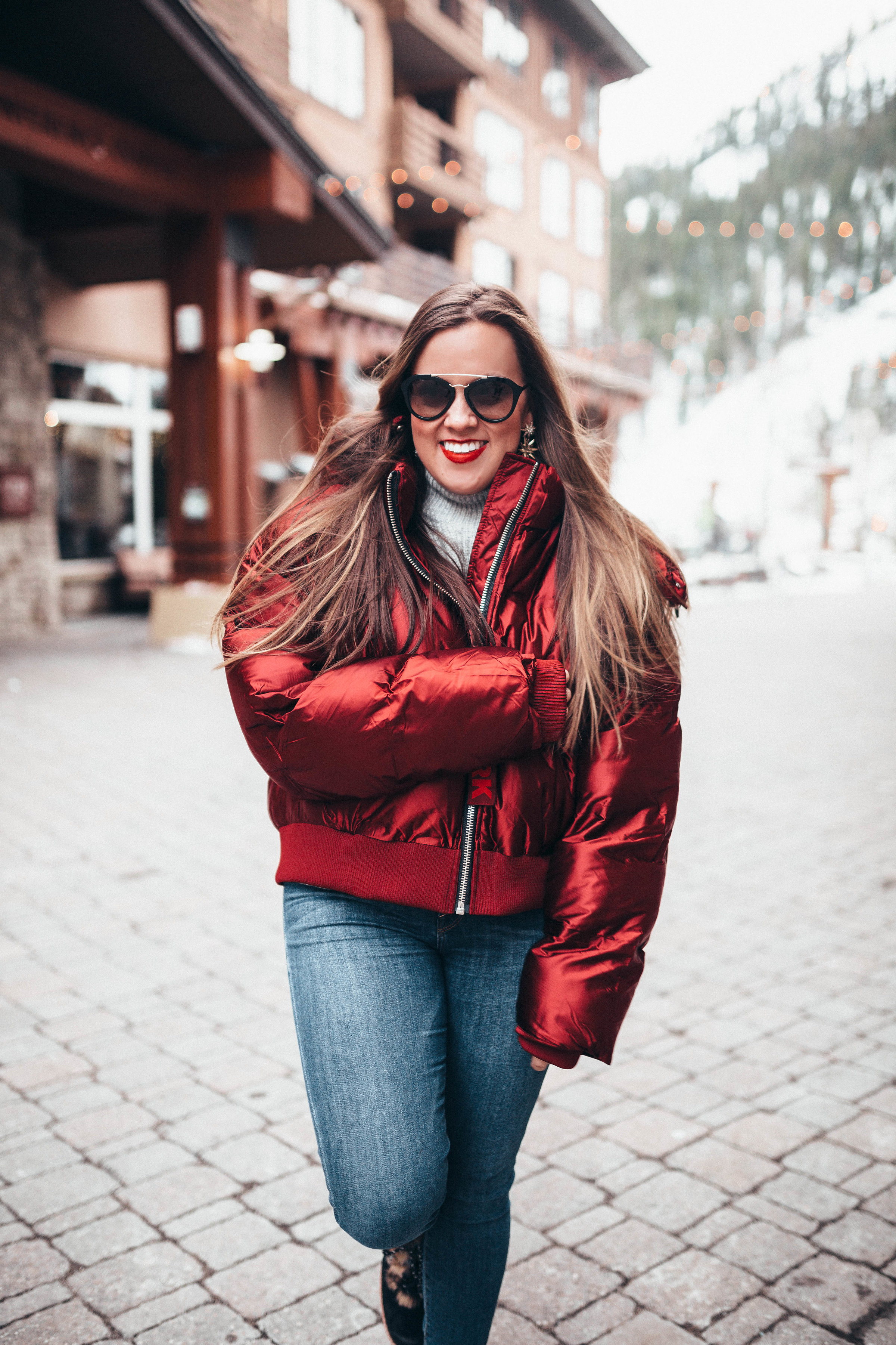 Ashley Zeal from Two Peas in a Prada shares a life and health update. She is wearing an Ivy Park Puffer jacket, Good American Jeans and Sam Edelman boots. 