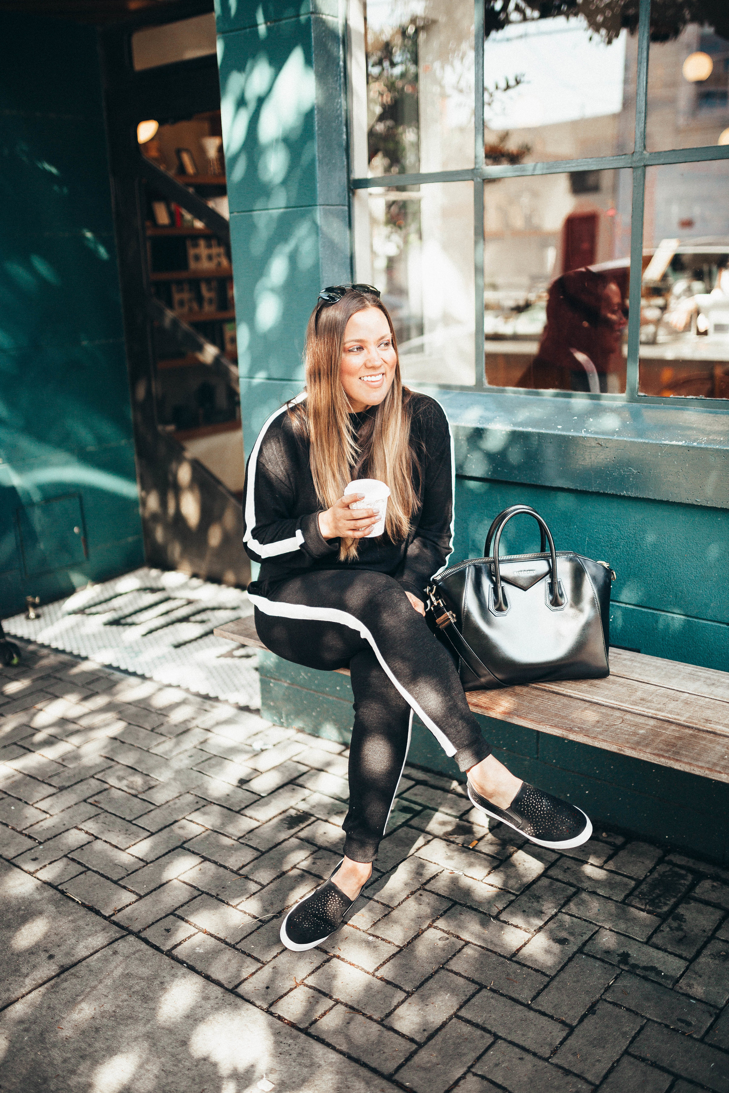 Ashley Zeal from Two Peas in a Prada shares her Friday OOTD which is a tracksuit under $80, perforated sneakers and a Givenchy available from Nordstrom! 