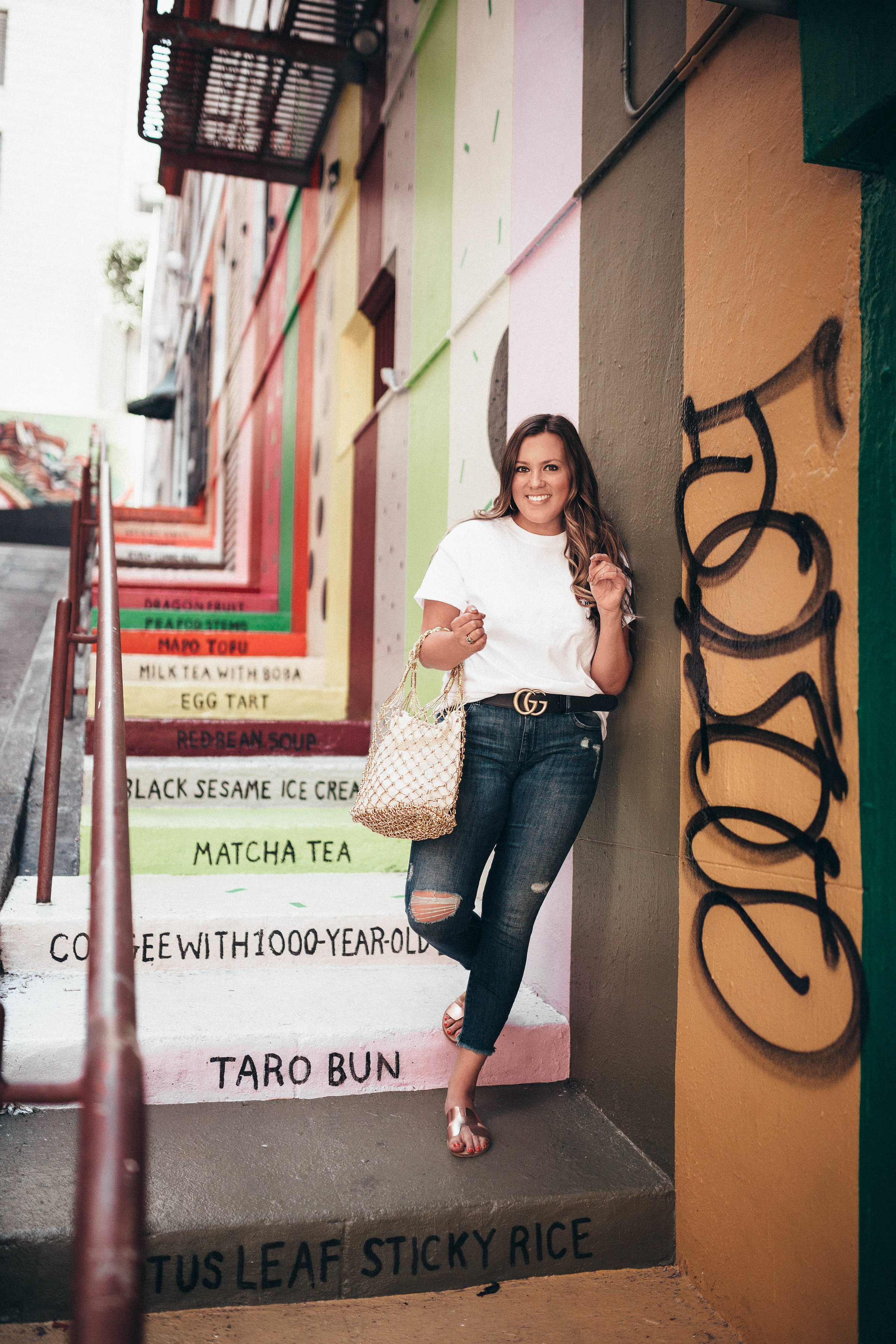 Ashley Zeal from Two Peas in a Prada shares the exact location of these colorful stairs in Chinatown. She is wearing a Bob's Big Boy graphic tee. 