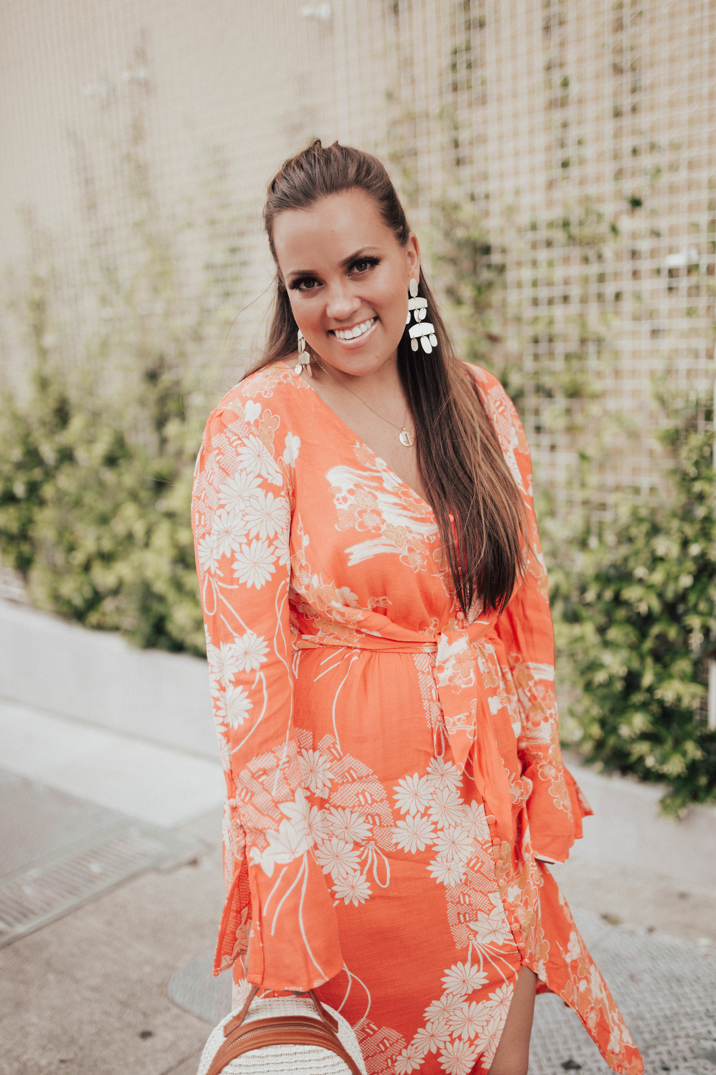 Ashley Zeal from Two Peas in a Prada shares a free people floral print midi dress on sale. 