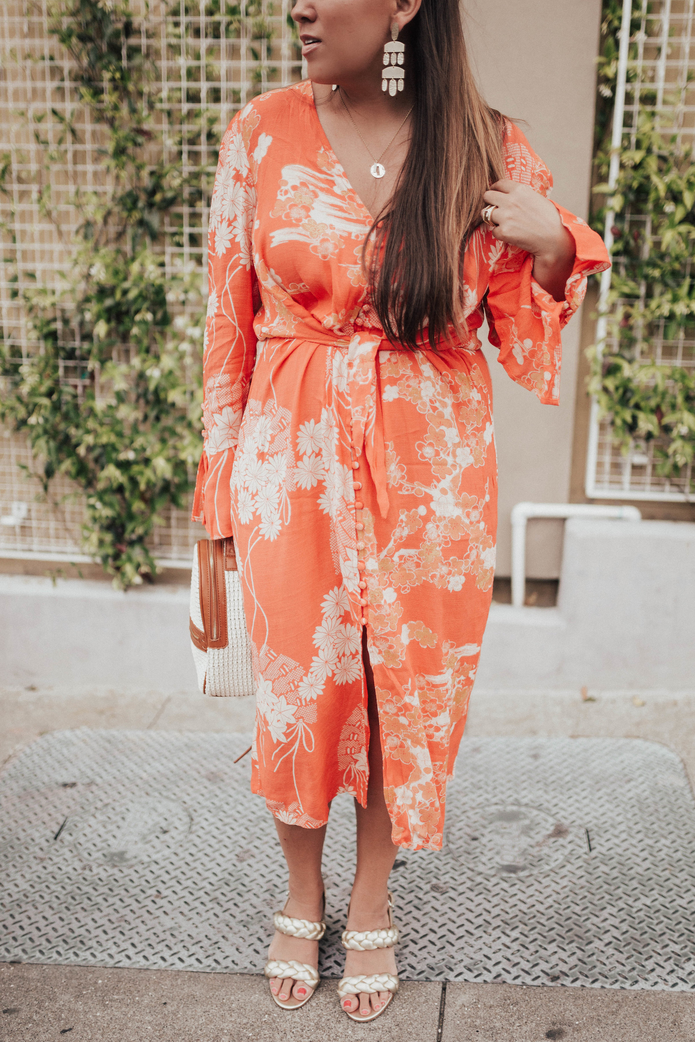 Ashley Zeal from Two Peas in a Prada shares a free people floral print midi dress on sale. 