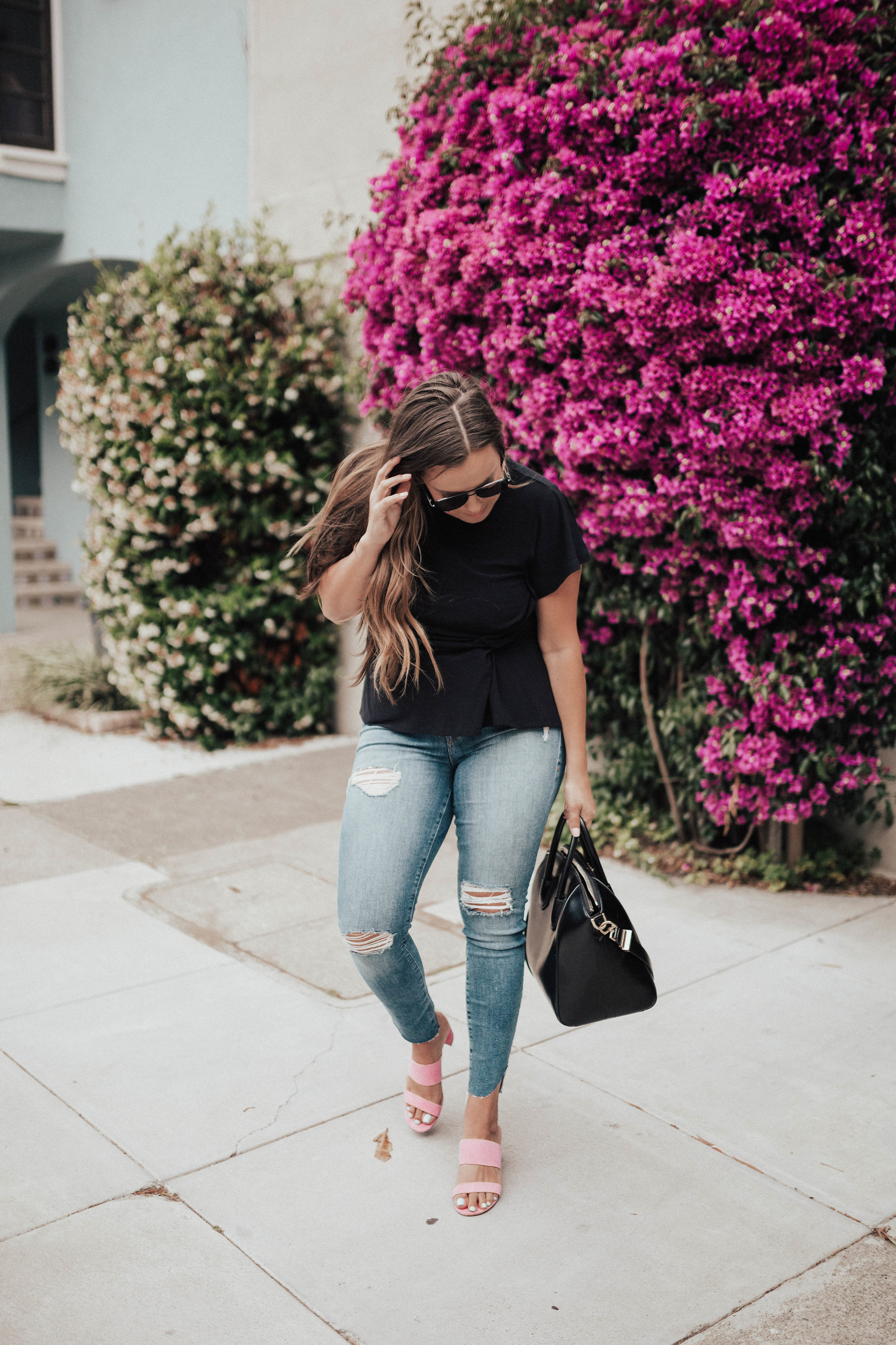 Ashley Zeal from Two Peas in a Prada shares a pair of Barbie Pink sandals by Kristin Cavallari. She is also wearing Good American Jeans and a Givenchy bag. 