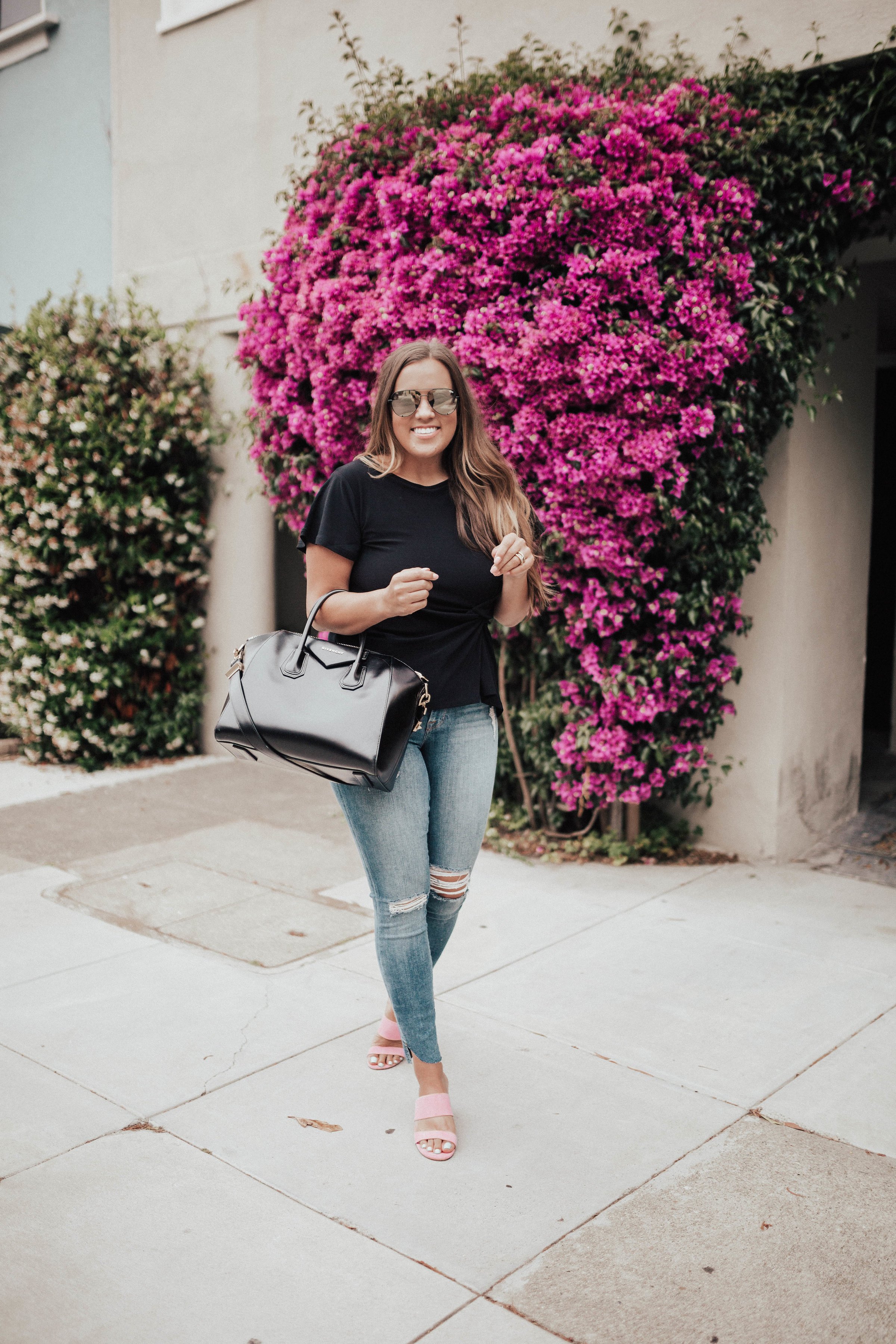 Ashley Zeal from Two Peas in a Prada shares a pair of Barbie Pink sandals by Kristin Cavallari. She is also wearing Good American Jeans and a Givenchy bag. 