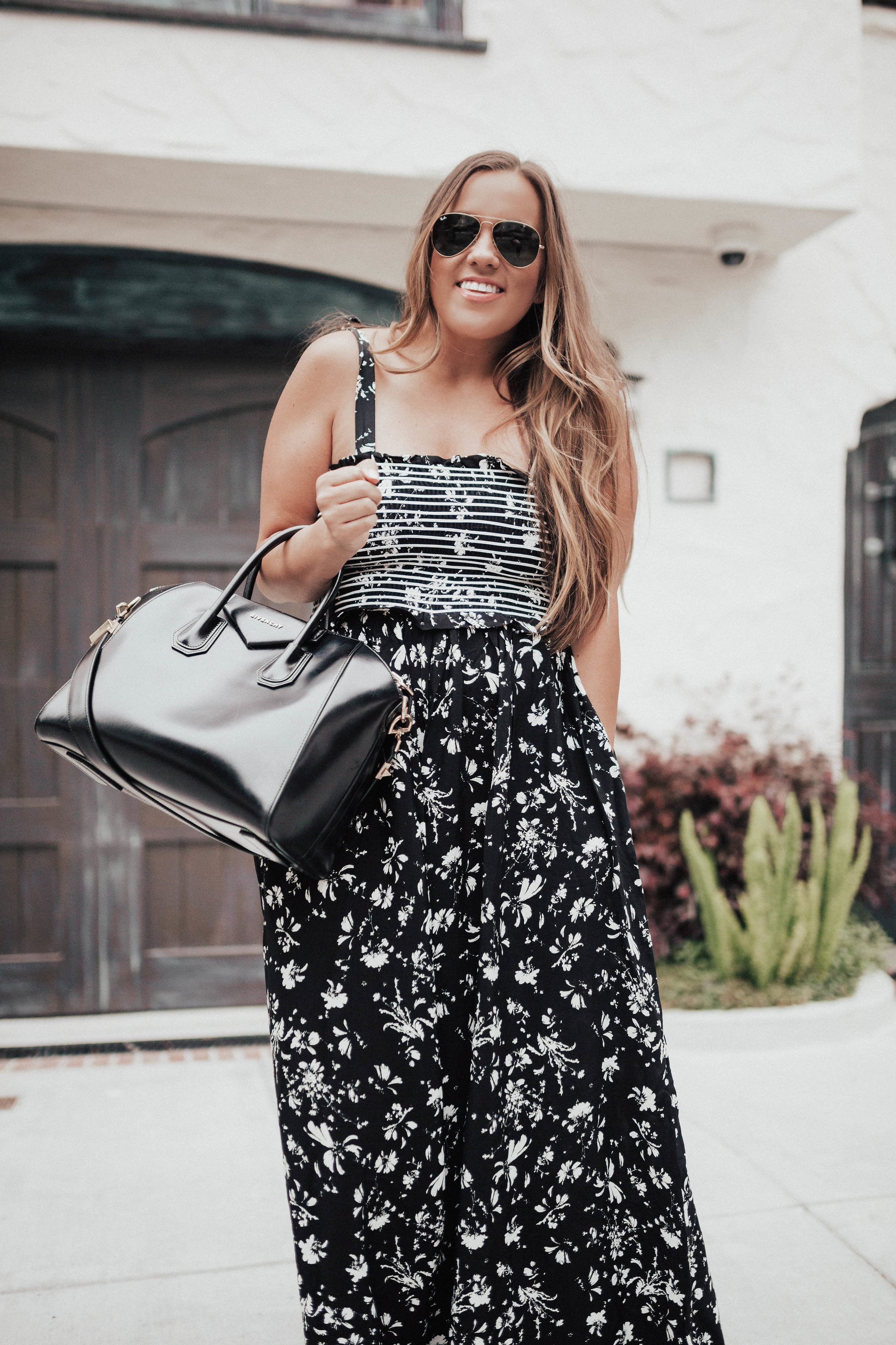 Ashley Zeal from Two Peas in a Prada shares her favorite pieces from the huge Free People Sale. She is wearing the Color My World Wide-Leg Jumpsuit. 