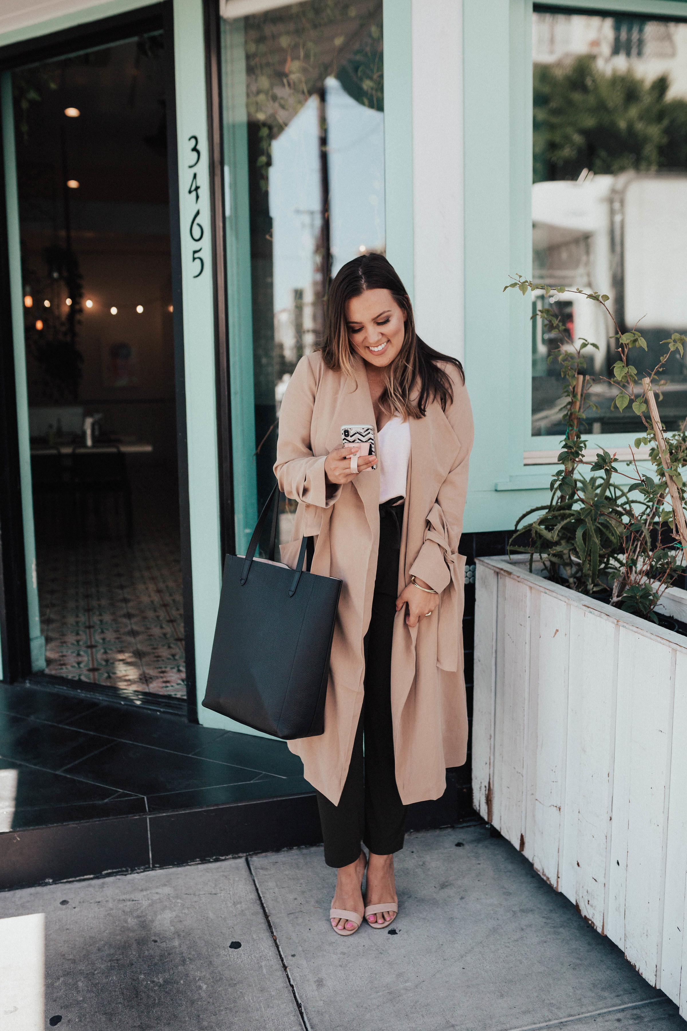 Ashley Zeal from Two Peas in a Prada partners with Express to share a fun Wear to Work outfit. She is wearing Express joggers, cami and trench. 