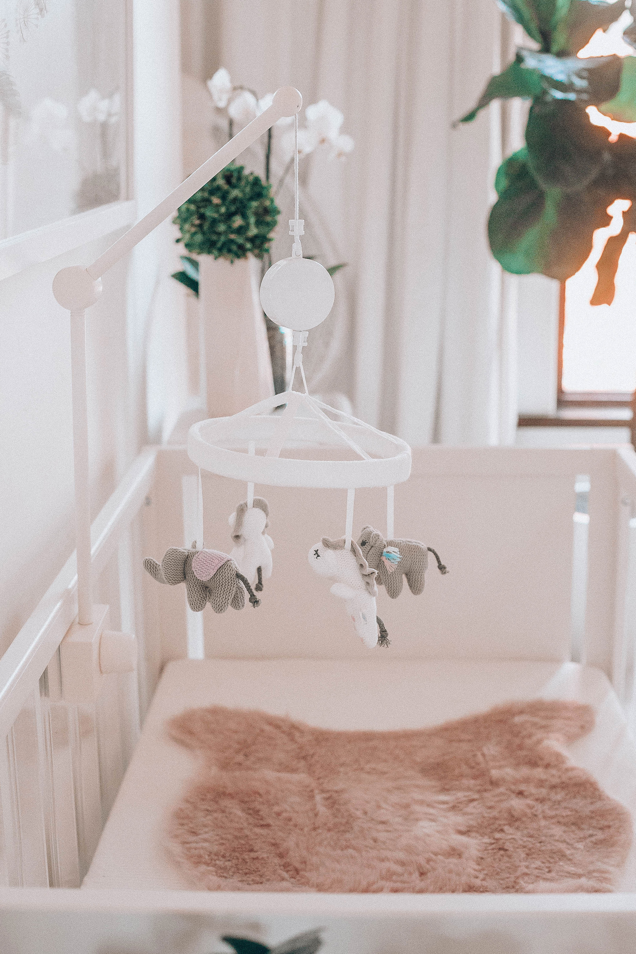 Emily Farren Wieczorek of Two Peas in a Prada shares baby Caroline's nursery - it is a modern baby nursery with pinks, golds and lots of natural greenery. 