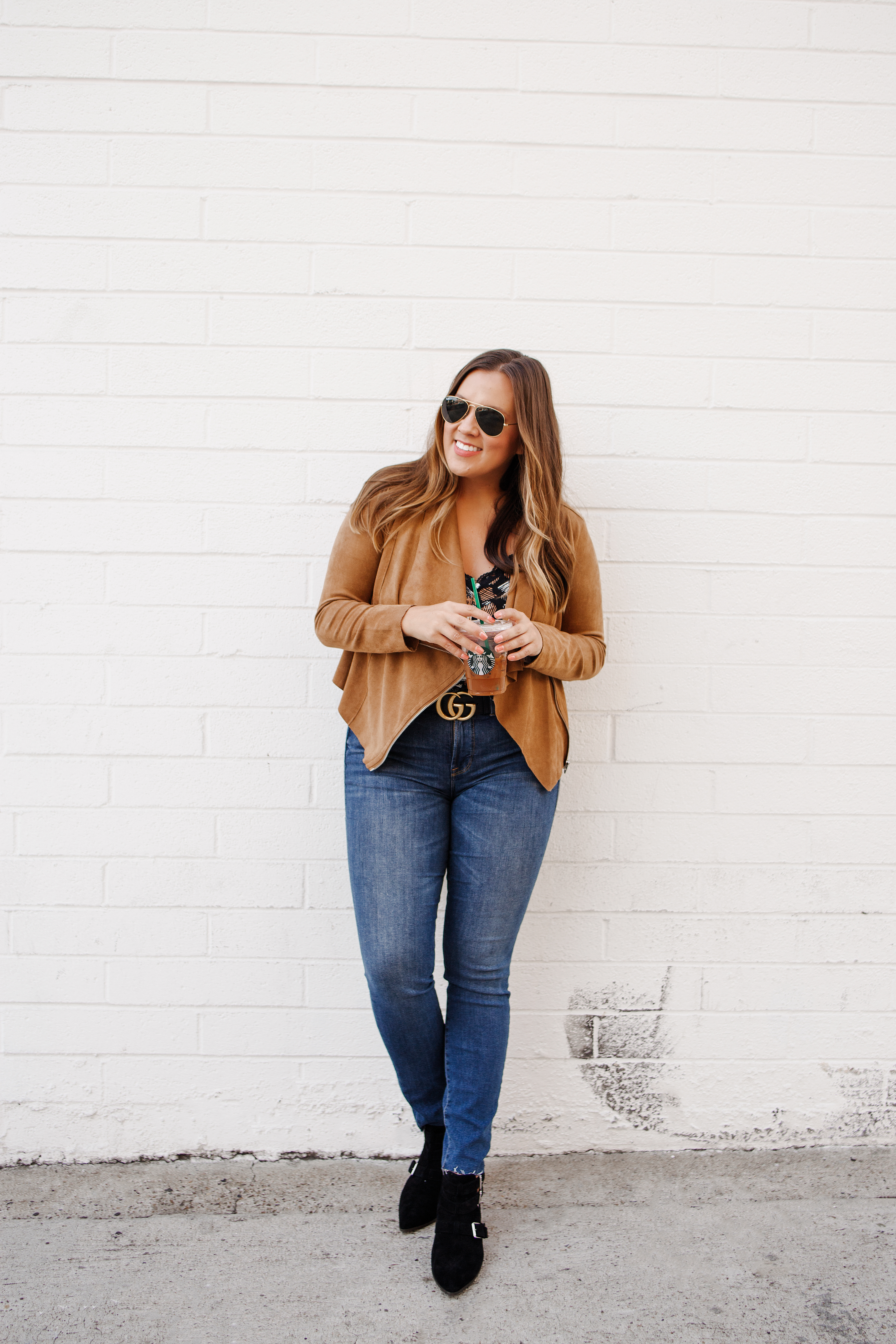 Ashley Zeal from Two Peas in a Prada shares an affordable faux suede jacket from Nordstrom. She is wearing the BlankNYC drape front faux suede jacket with jeans and booties. 