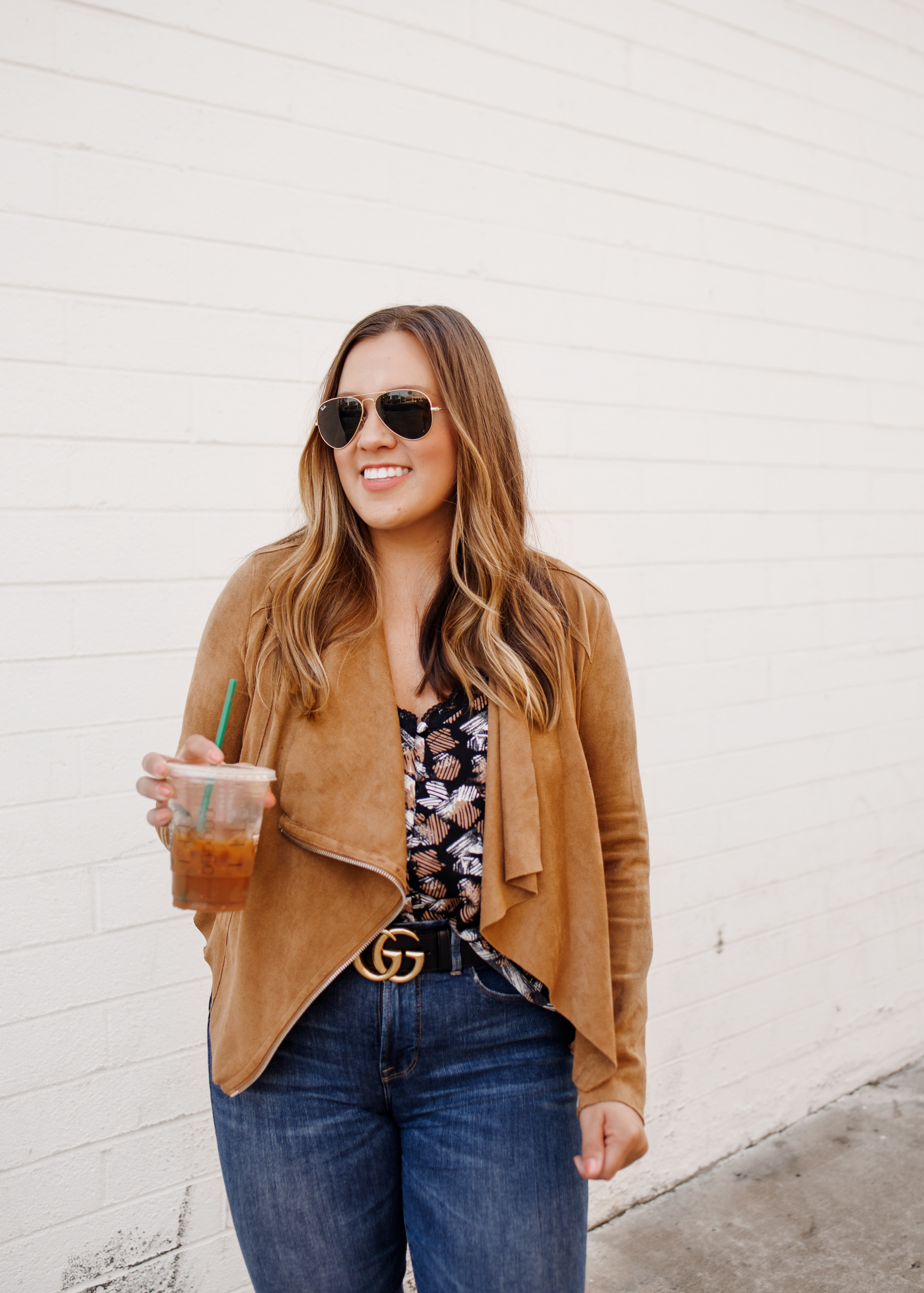 Ashley Zeal from Two Peas in a Prada shares an affordable faux suede jacket from Nordstrom. She is wearing the BlankNYC drape front faux suede jacket with jeans and booties. 