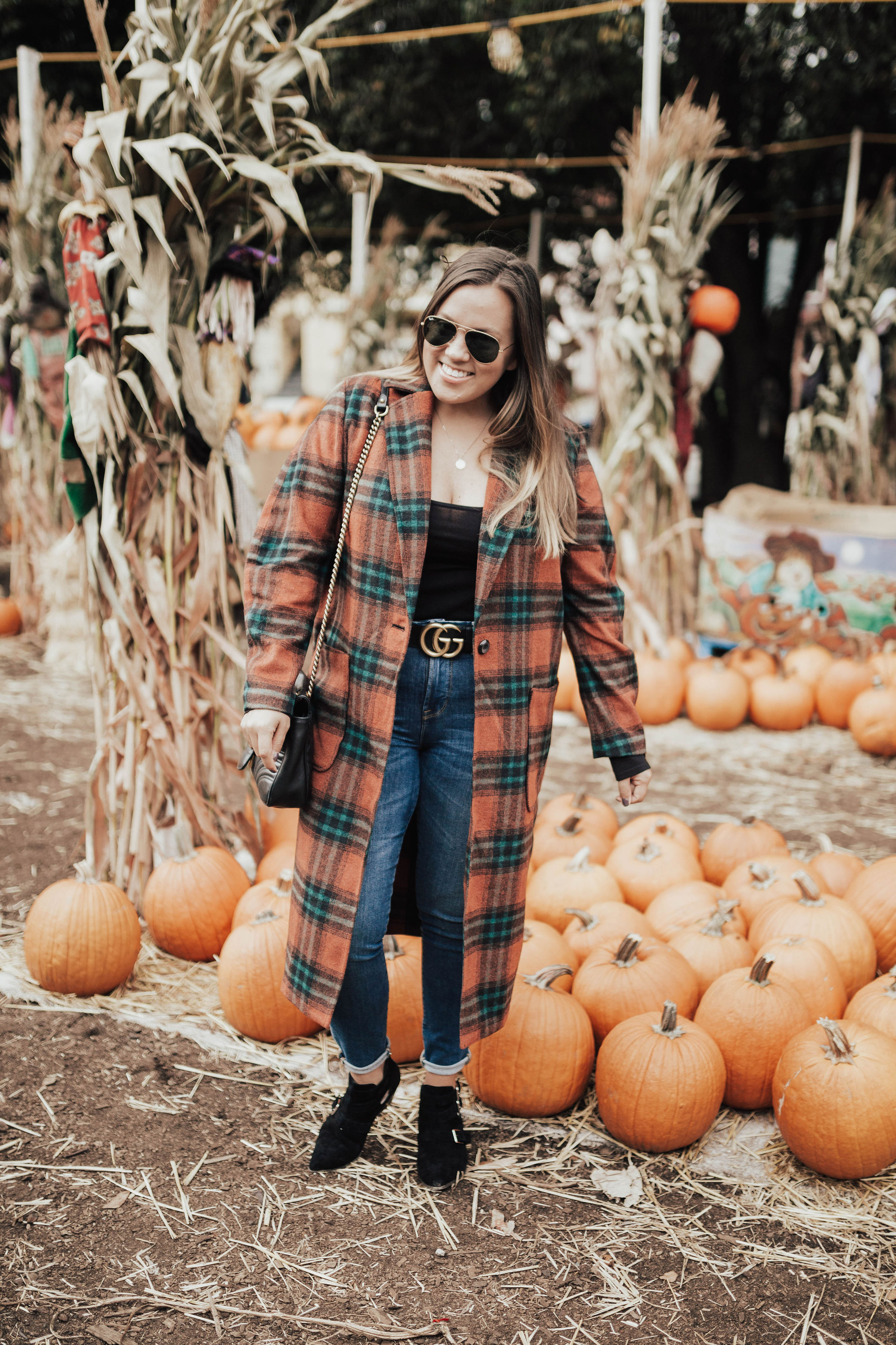 Ashley Zeal from Two Peas in a Prada shares her pumpkin patch outfit. She is wearing the Leith single button plaid coat. 