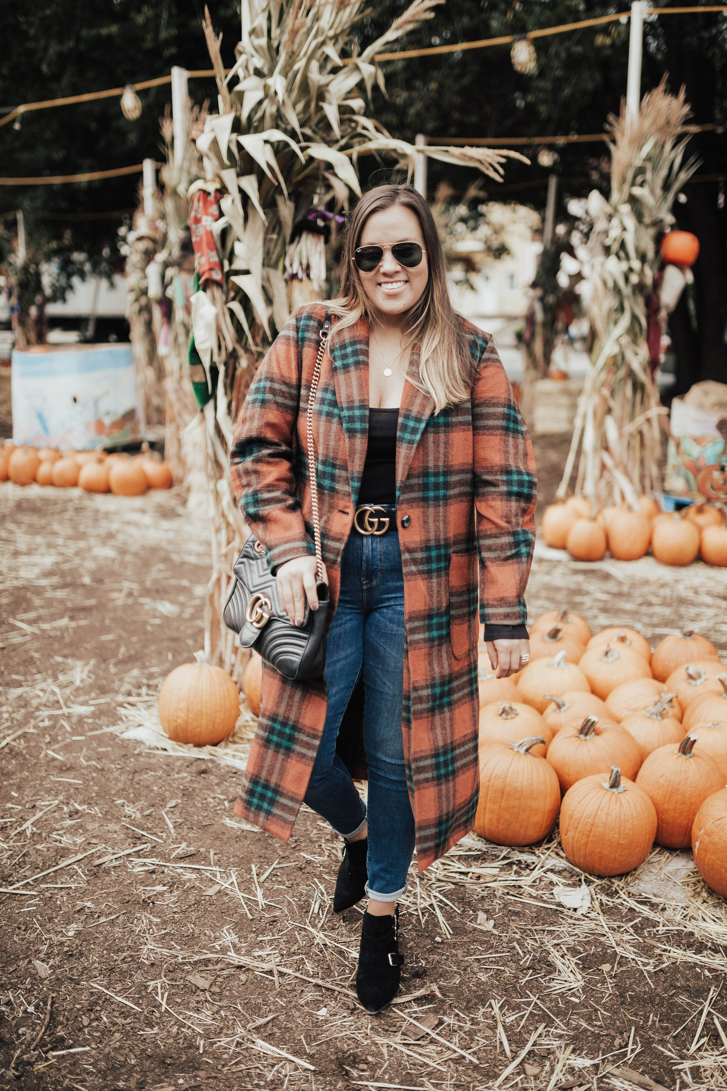 Ashley Zeal from Two Peas in a Prada shares her pumpkin patch outfit. She is wearing the Leith single button plaid coat. 