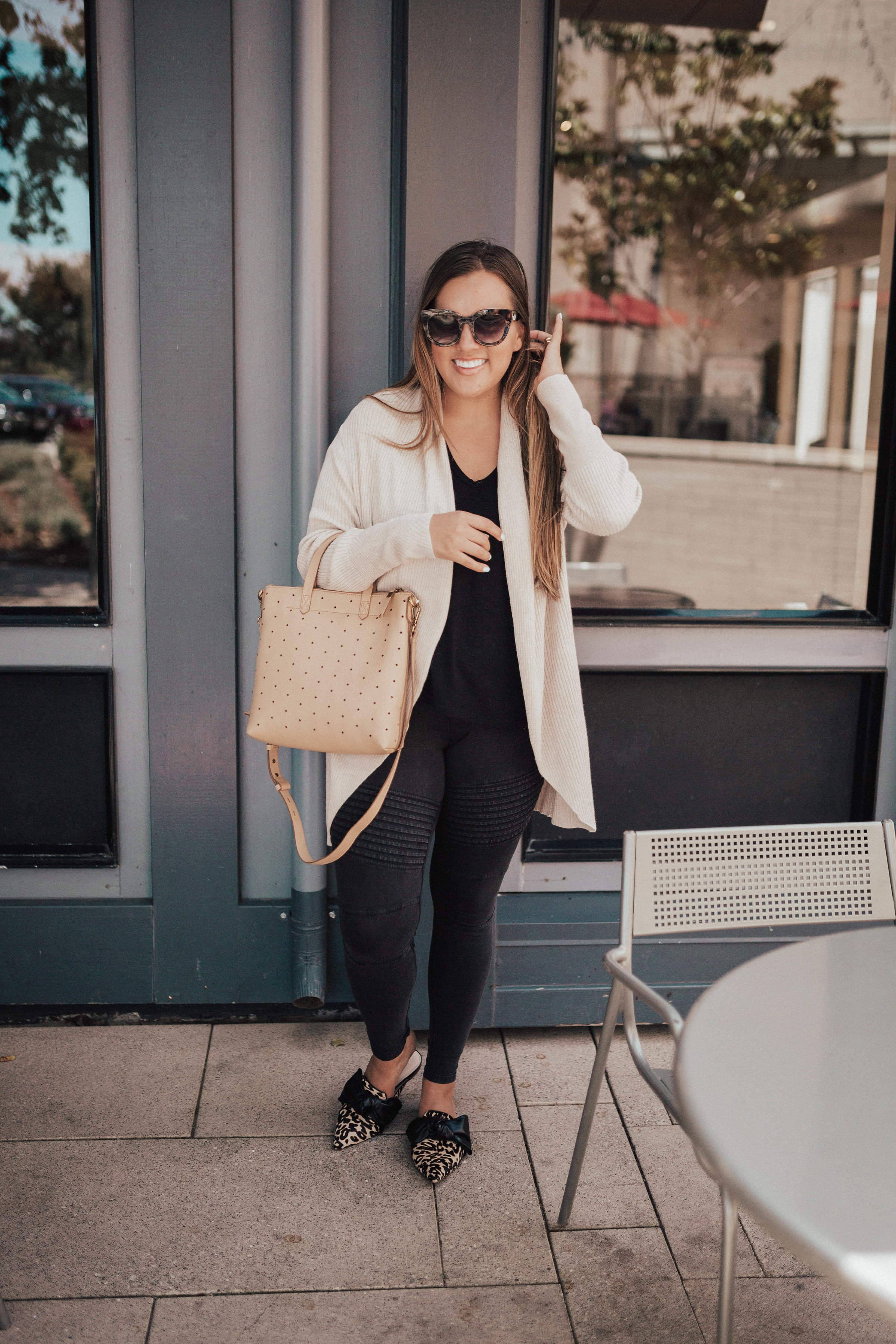 Ashley Zeal from Two Peas in a Prada shares their September Top Ten Sellers. She is wearing leopard mules, a leith cardigan and moto leggings. 