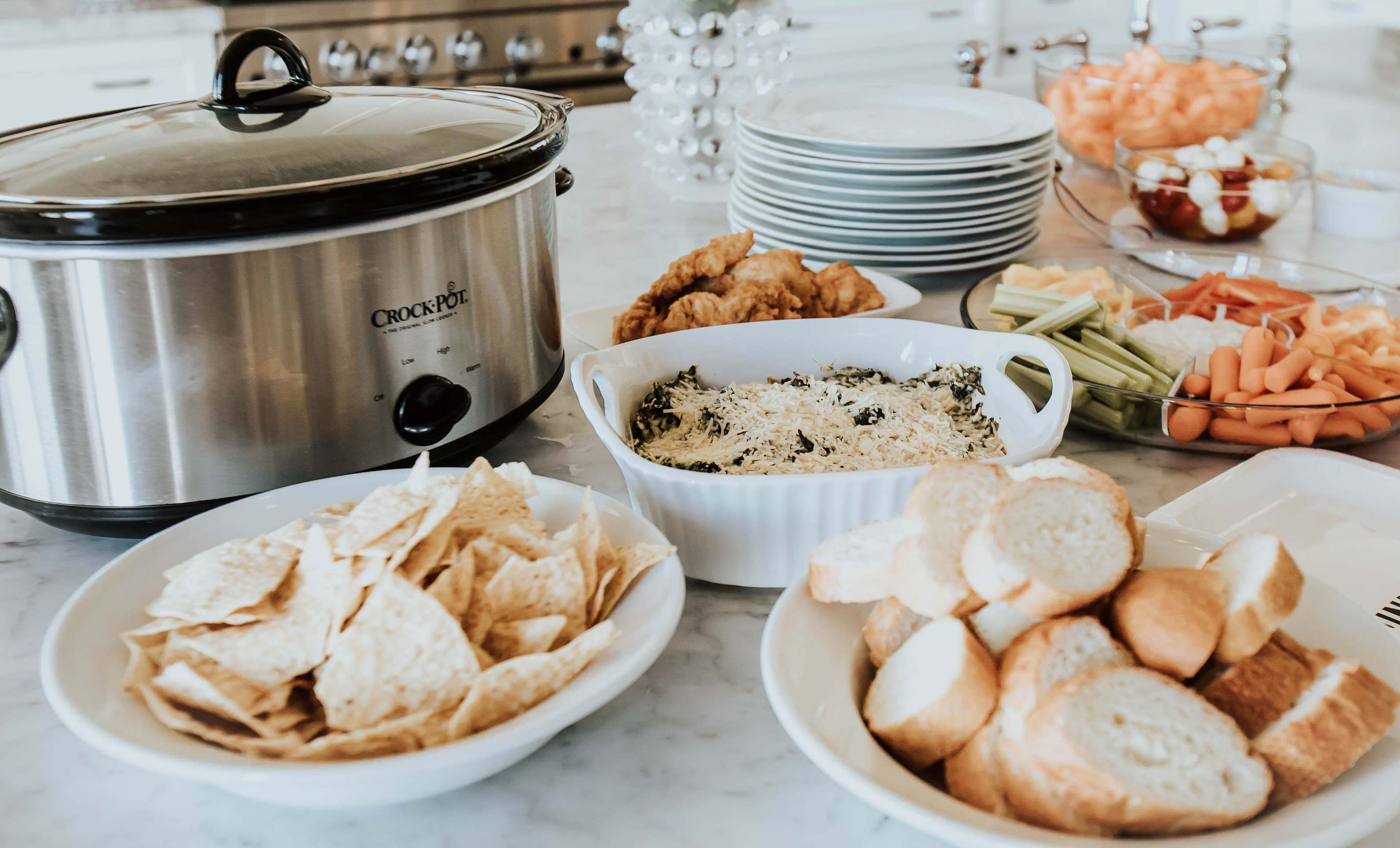 Two Peas in a Prada Bloggers, Emily Farren Wieczorek and Ashley Zeal share their favorite Super Bowl snack - this amazing healthy Spinach Artichoke Dip