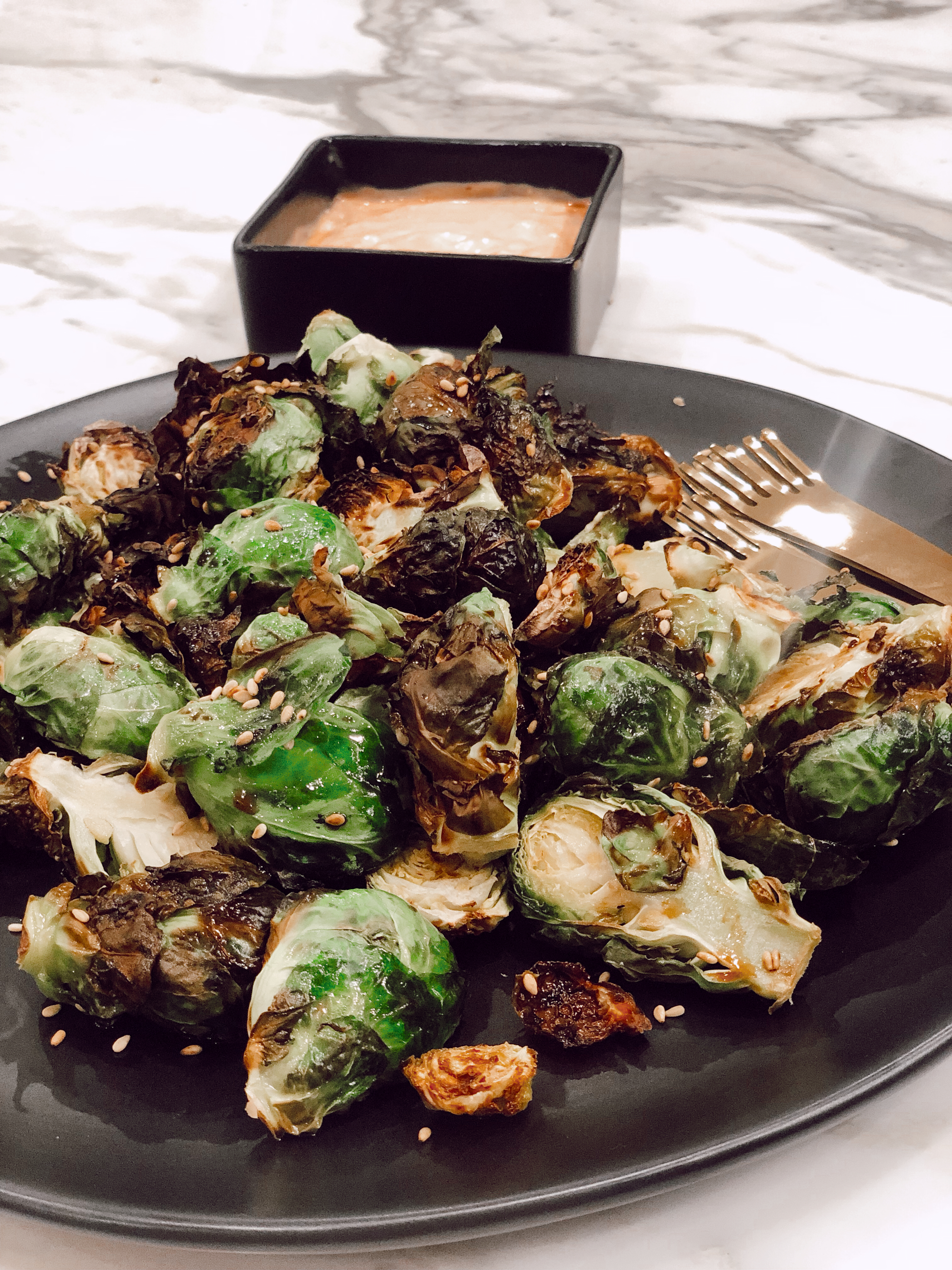 Two Peas in a Prada Co-Founder, Emily Farren Wieczorek shares all of her favorite air fryer recipes - chicken wings, brussell sprouts and french fries in Em's Easy Air Fryer Recipes